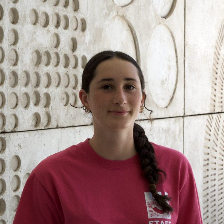 woman smiling in a pink Tucson J shirt