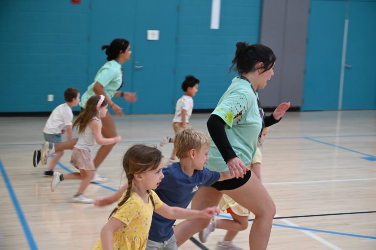 kids running across a gymnasium
