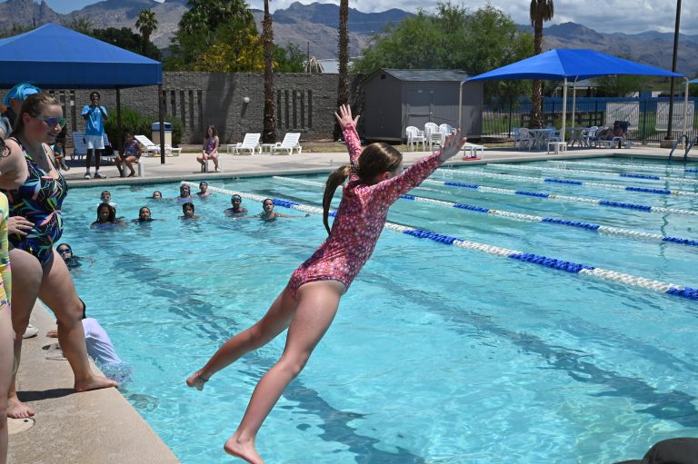 kid jumping in the pool