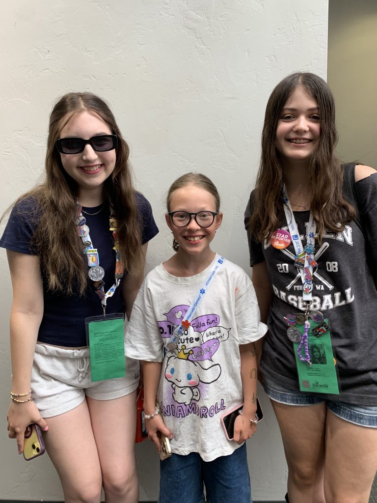 three teens standing together and smiling